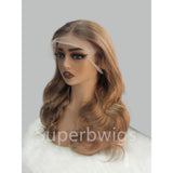 Blonde wavy human hair wig with 13x6 transparent lace front and natural ombre gradient in soft voluminous curls
