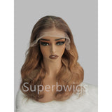 A 13x6 transparent lace front human hair wig with a pre-plucked hairline, wavy texture, and subtle brown ombre highlights