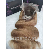 A 13x6 transparent lace front human hair wig with a natural ombre color and soft wavy body texture