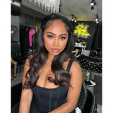 Black corset-style dress with thin straps and vertical seam detailing paired with a lace upgraded hairline wig